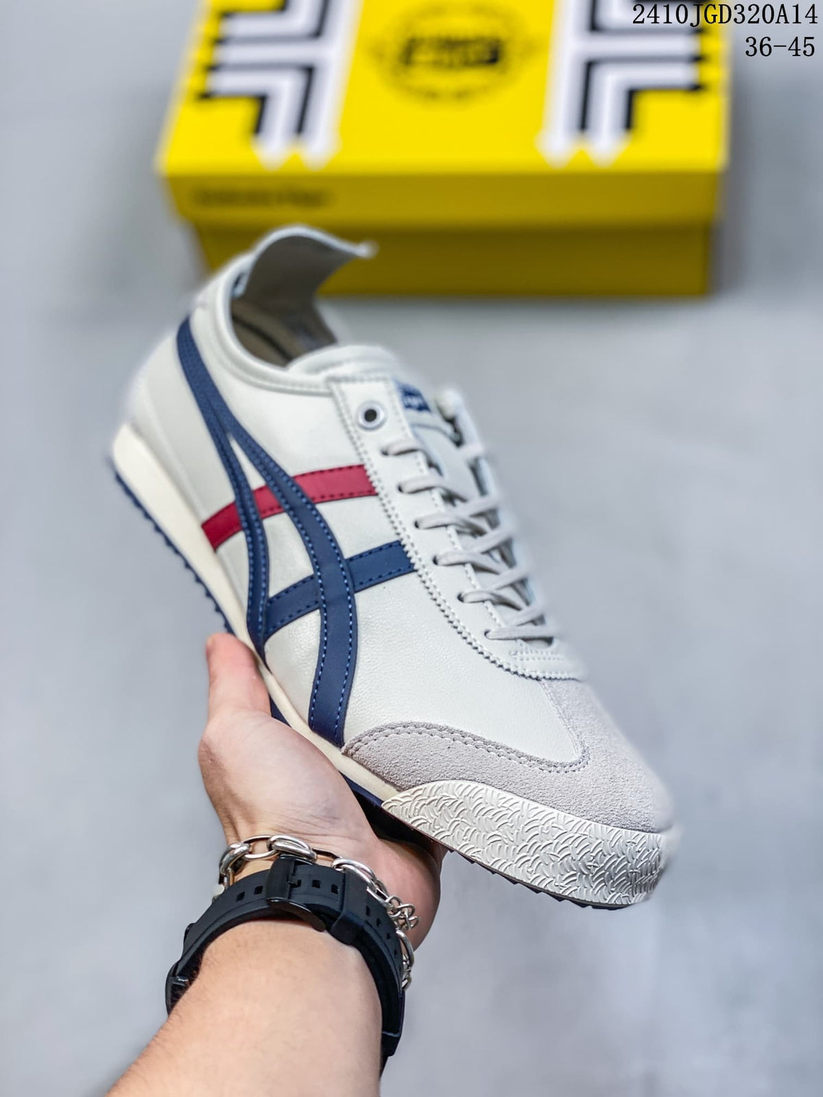 Angled side view of the white sneaker with navy blue and red stripes