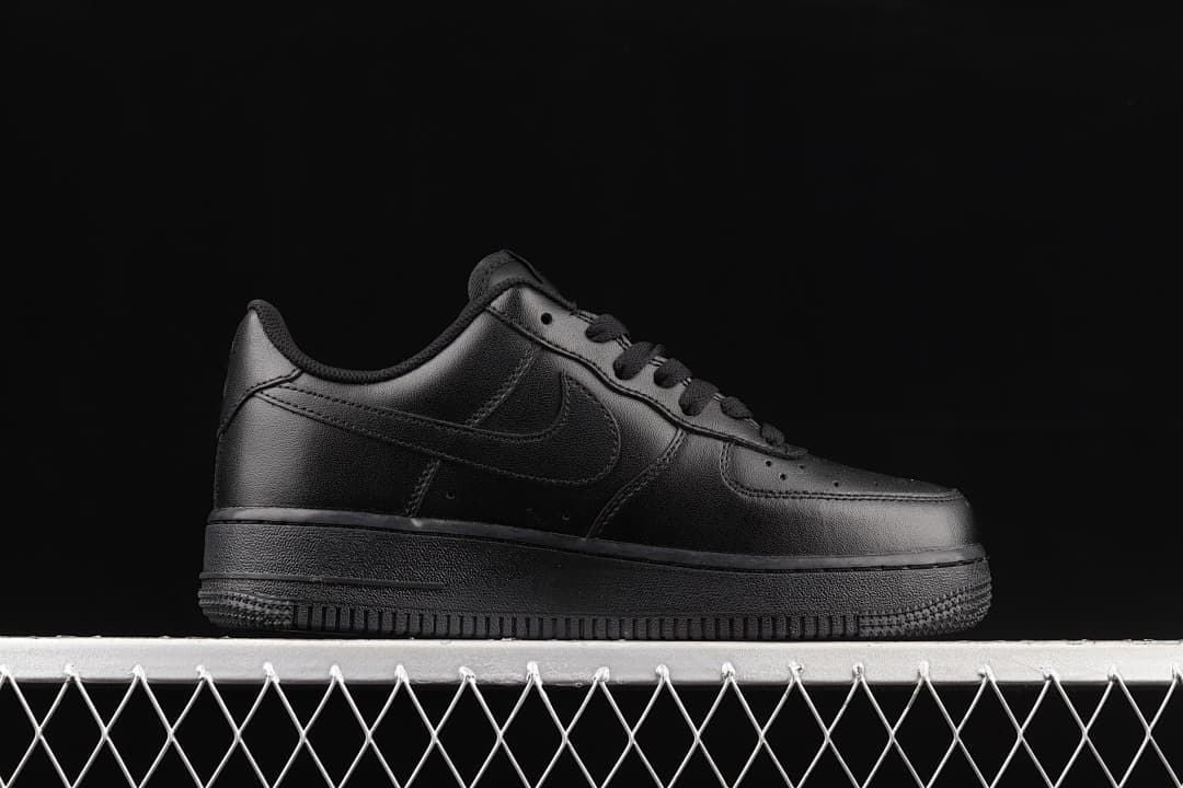 Side profile of an all-black Nike Air Force 1 '07 Low sneaker.