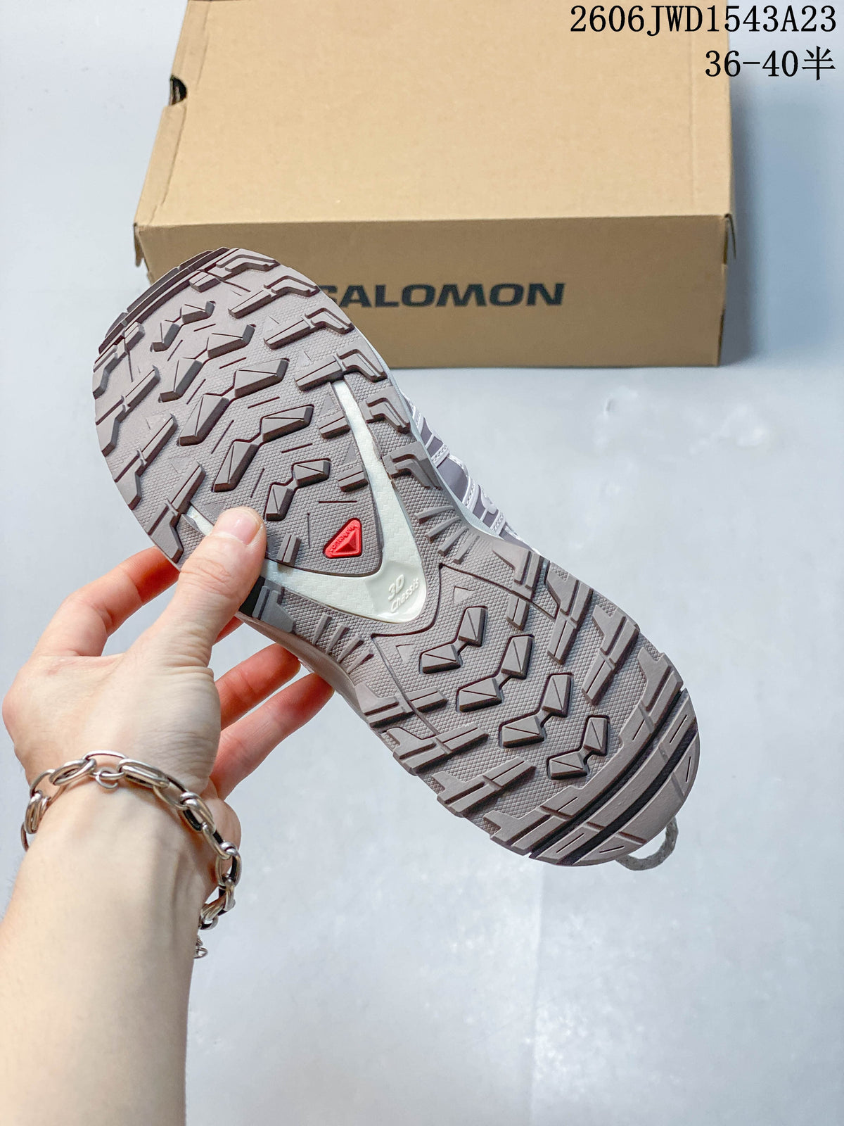 Close view of the lugged outsole on a Salomon XA Pro 3D shoe; image overlay lists sizes 36–40.5.