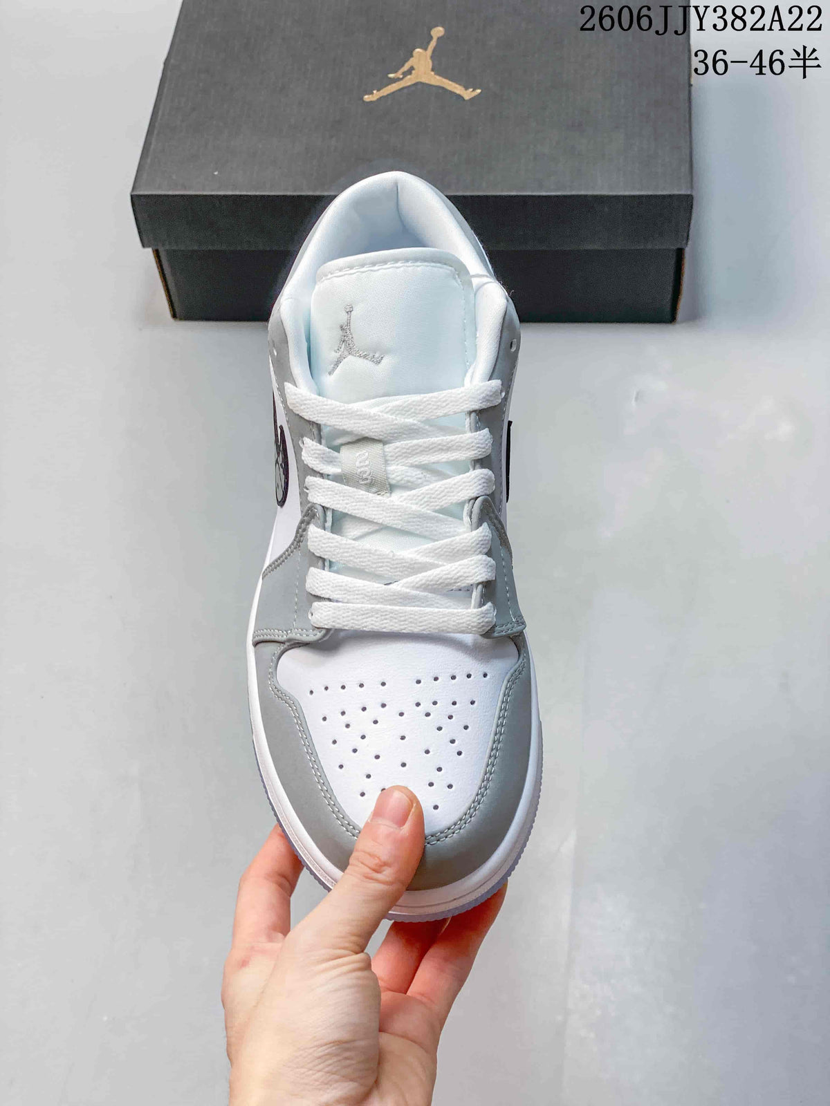 Top view showing white laces and perforated toe box on the grey and white sneaker