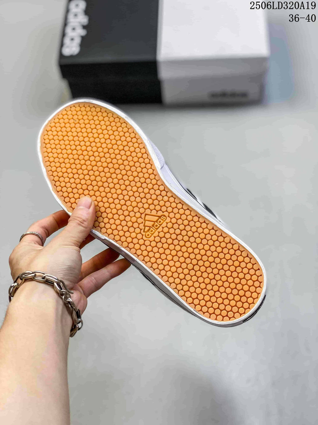 Underside of a sneaker showing a gum-colored outsole with a circular tread pattern.