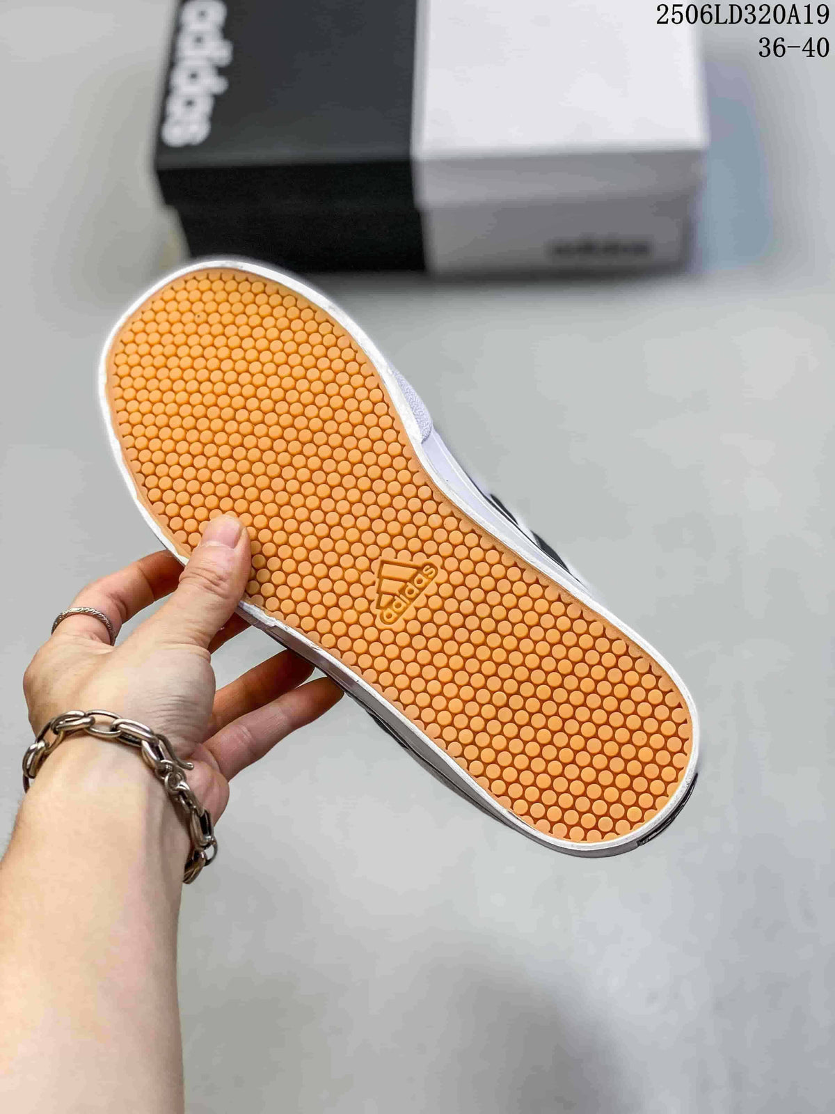 Underside of a sneaker showing a gum-colored outsole with a circular tread pattern.