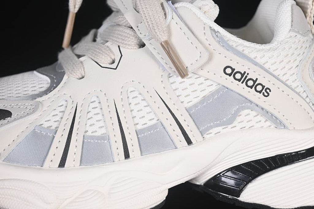 Close-up of side panels, laces, strap, and sole