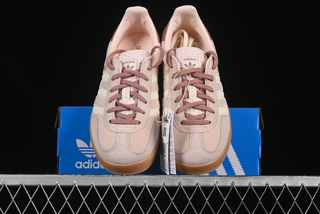 Front view of the pair displayed on an adidas box