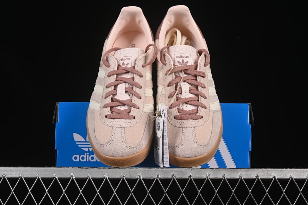 Front view of the pair displayed on an adidas box