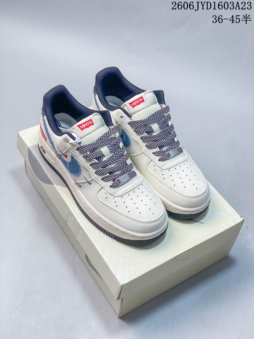 Pair of off-white Nike Air Force 1 '07 low-top sneakers with blue overlays, red Levi’s® labels, patterned laces, and a shoebox