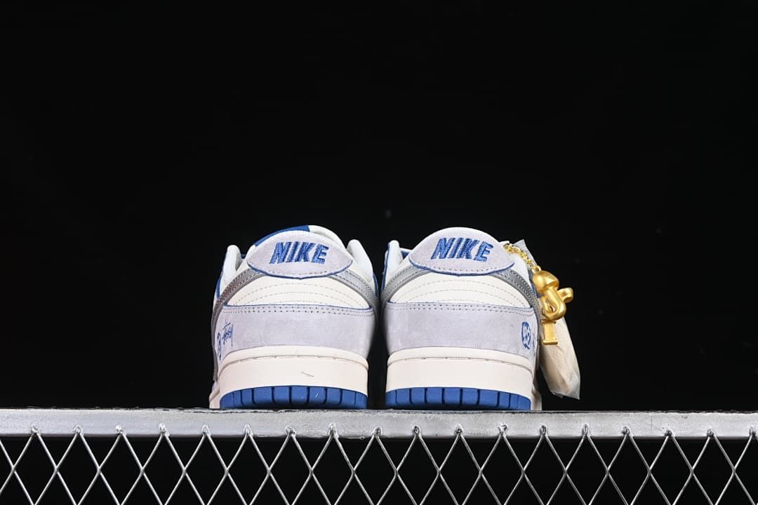 Rear view of the pair showing heel details and blue outsole sections
