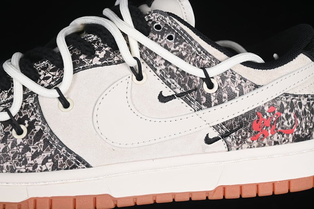Close-up of the side panels, white Swoosh, patterned overlays, and red accent