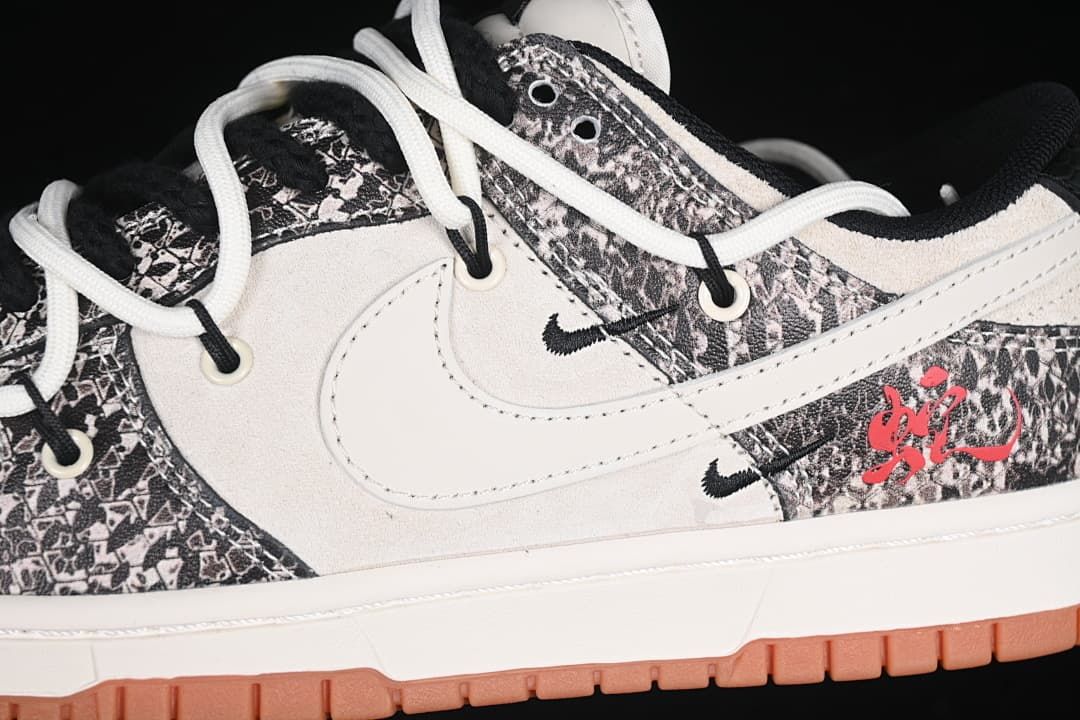 Close-up of the side panels, white Swoosh, patterned overlays, and red accent