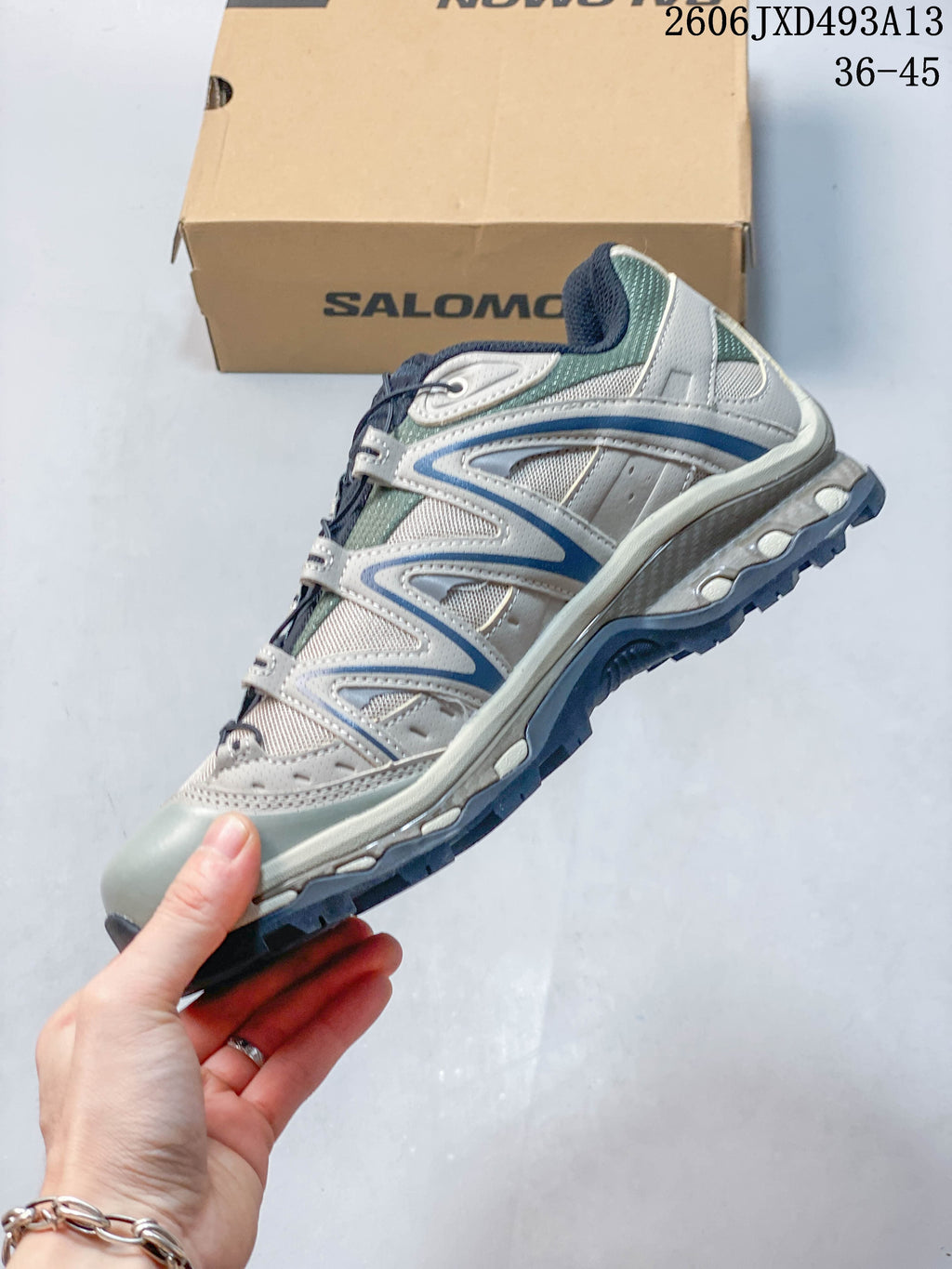 Side profile showing mesh panels, layered overlays, and a lugged sole.