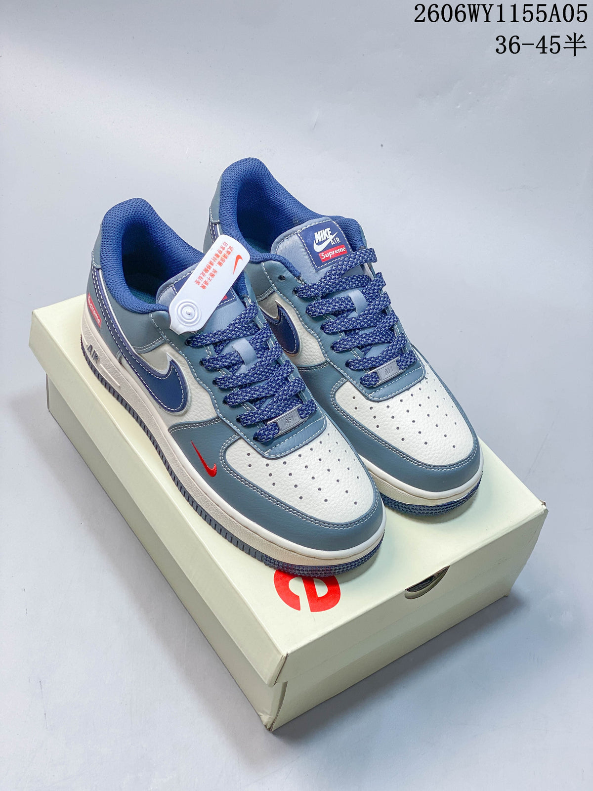 White and blue low-top sneakers with red accents, shown on a box