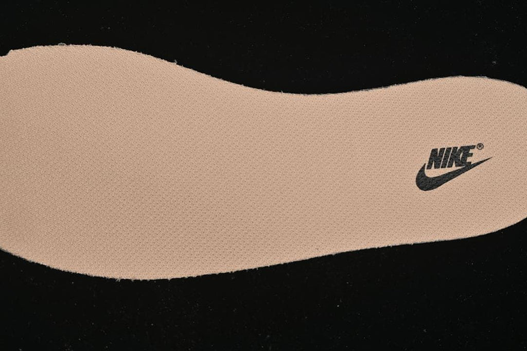 Close-up of a tan shoe insert with a Nike logo