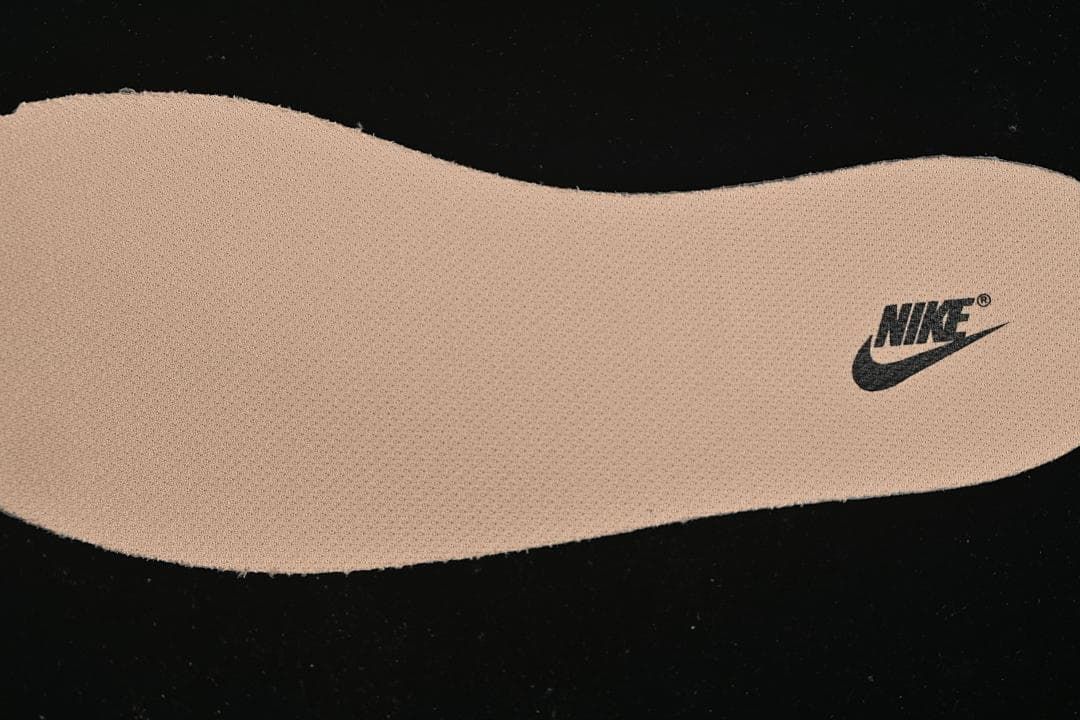 Close-up of a tan shoe insert with a Nike logo