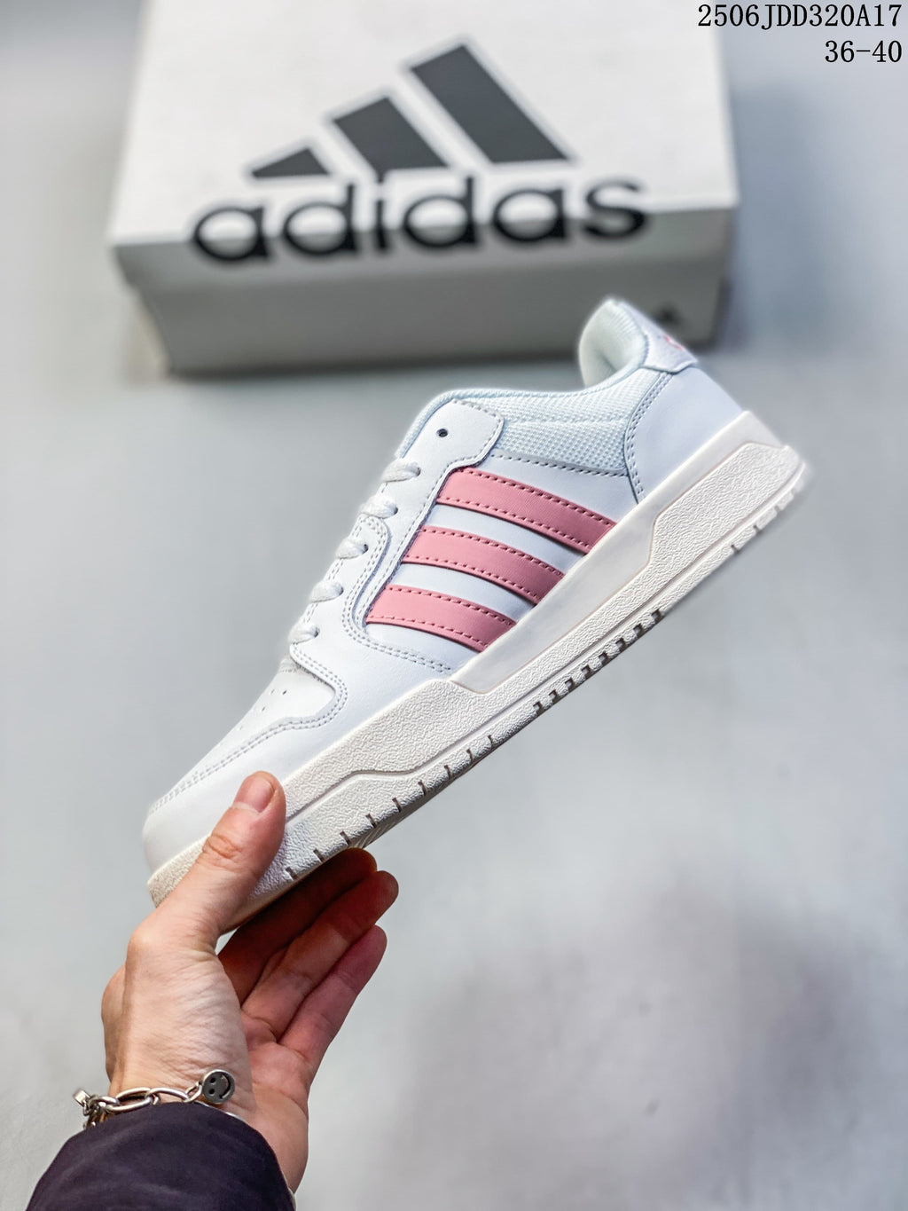 Side view of a white adidas Entrap sneaker showing pink stripes and a textured sole