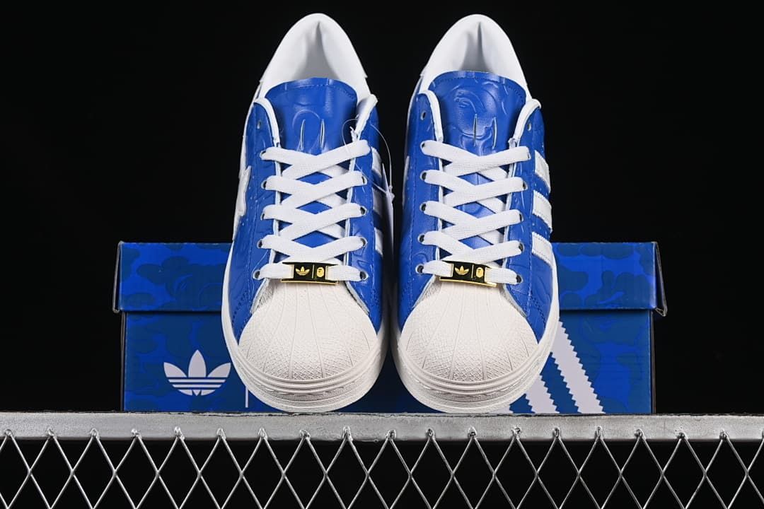 Front view of both sneakers displayed on the box