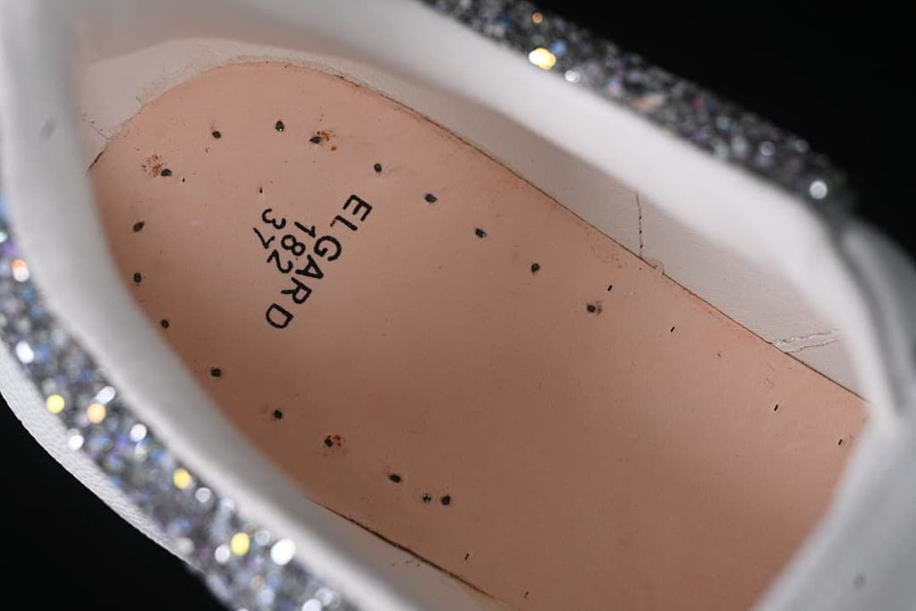 Close-up inside the shoe showing printed text on the insole.