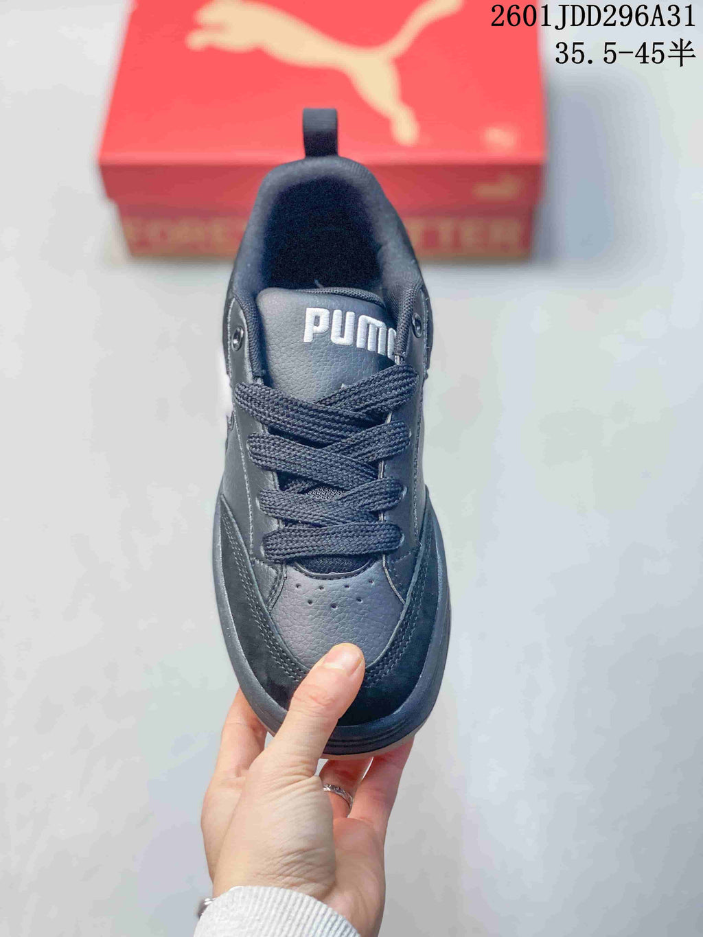 Top view of a dark lace-up sneaker with a padded collar and perforated toe area