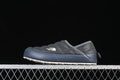 Side profile of a grey quilted The North Face mule with a blue sidewall and light outsole