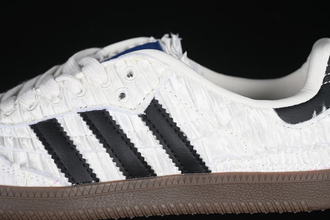 Close-up of the black side stripes against the textured white upper