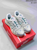 White Nike P-6000 sneakers with teal accents, shown on a red shoebox.