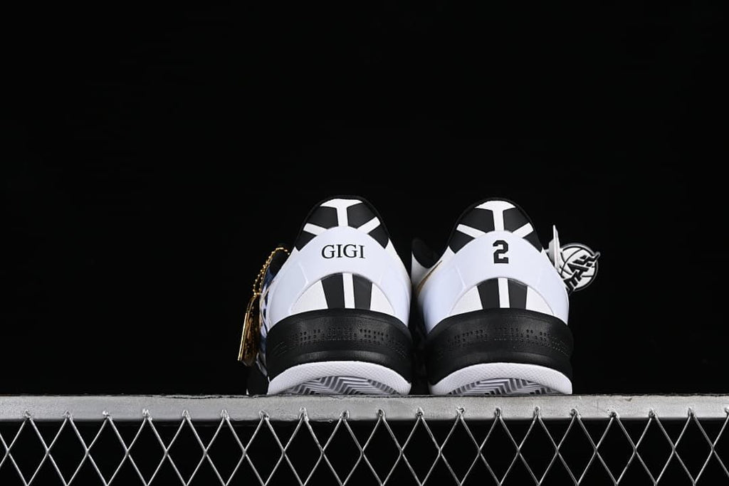 Rear view of the shoes showing heel graphics and black-and-white detailing.