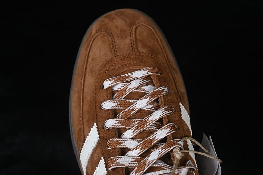 Top-down close-up of the brown toe and patterned laces