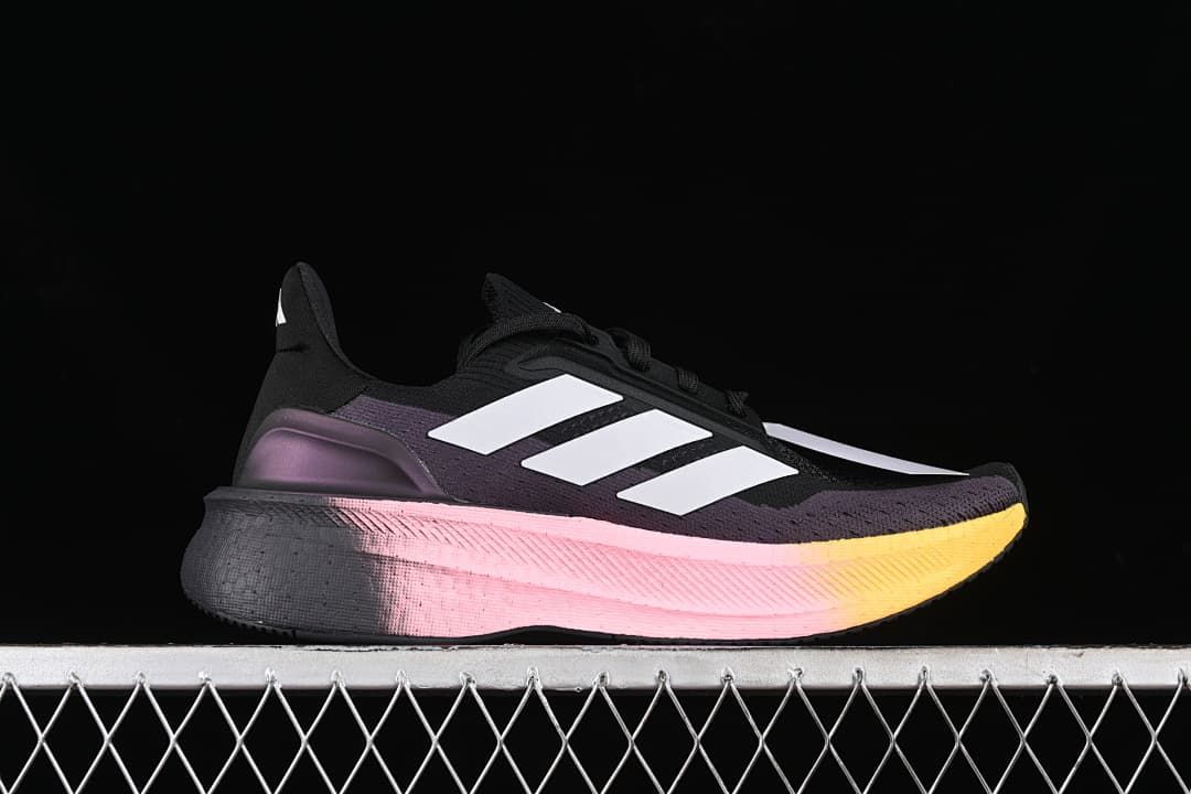 Side profile with white stripes and a pink-to-yellow gradient midsole.