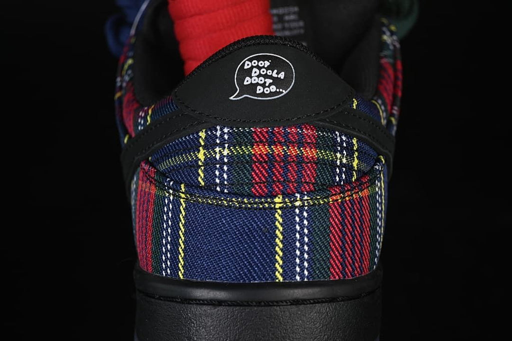 Rear view showing plaid panels and a speech-bubble graphic on the heel tab.