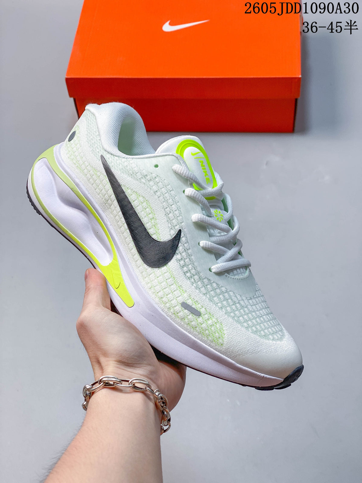 White Nike Journey Run running shoe with purple accents and a patterned upper.