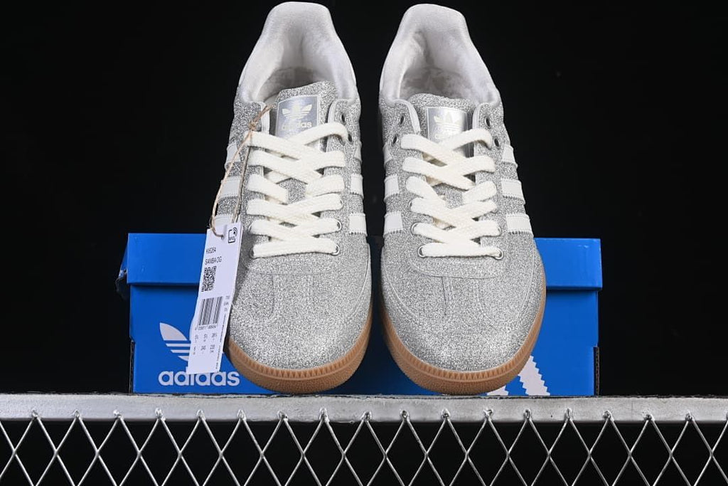 Front view of the pair displayed on a blue adidas box.