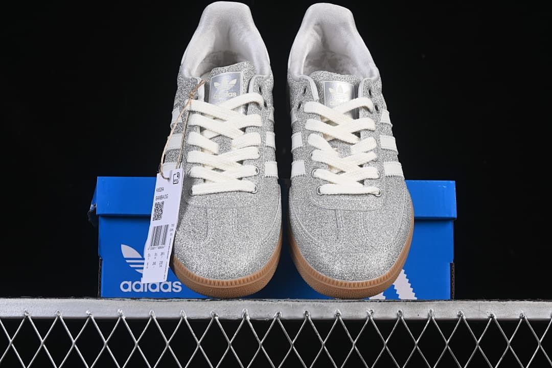 Front view of the pair displayed on a blue adidas box.