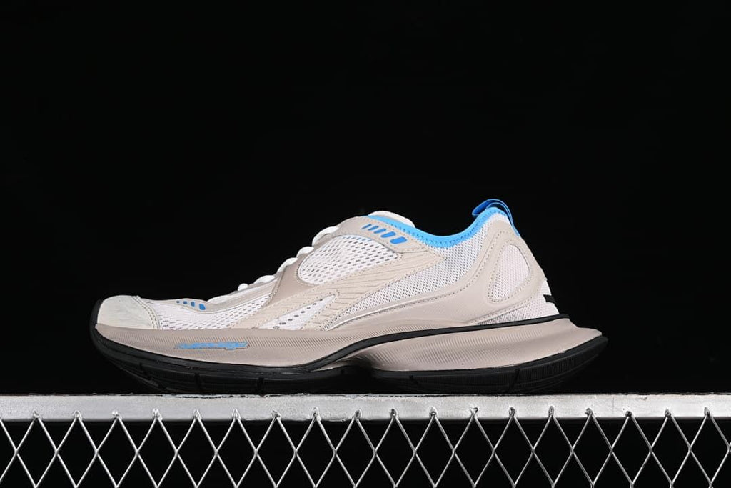 Side profile of beige and blue Balenciaga Circuit sneakers