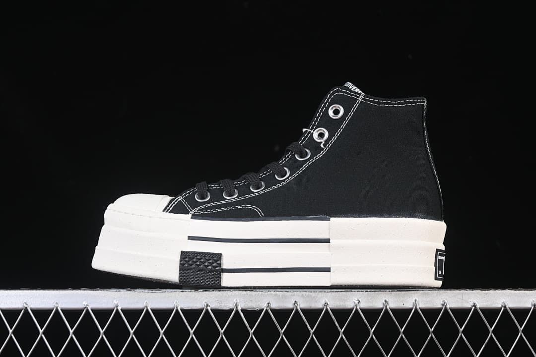 Side profile of a black high-top sneaker with white contrast stitching and thick white sole