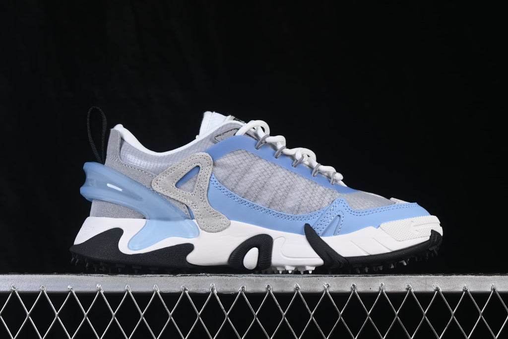 Side profile of the sneaker showing grey panels, blue trim, and sculpted sole