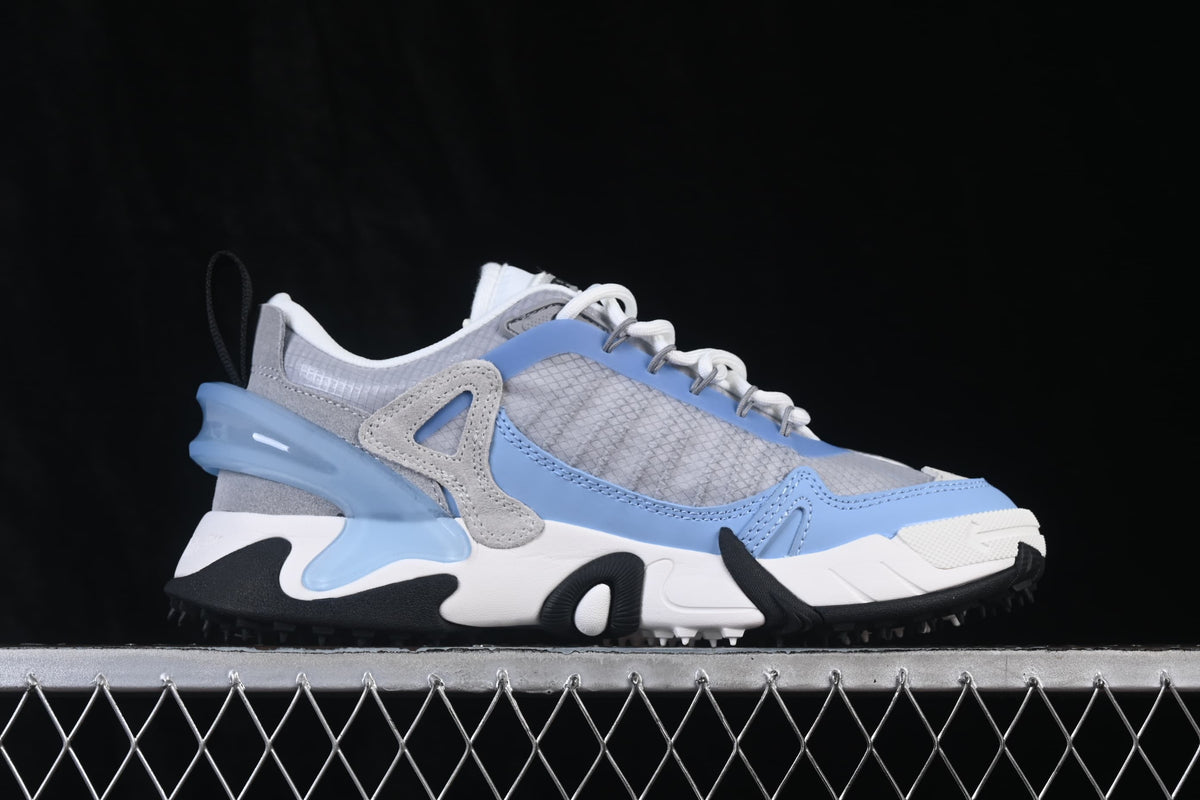 Side profile of the sneaker showing grey panels, blue trim, and sculpted sole