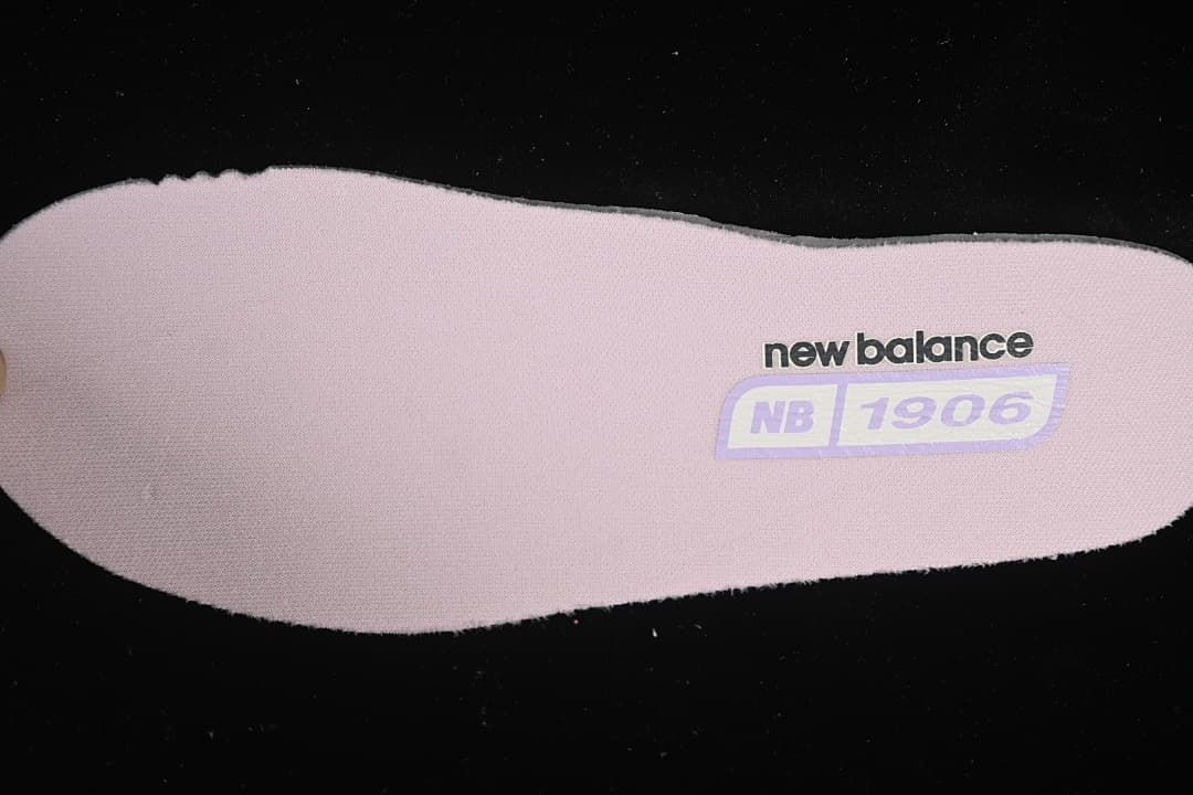 Pink insole with New Balance 1906 branding.