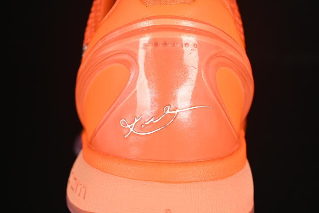 Rear view of orange shoe with Kobe signature detail