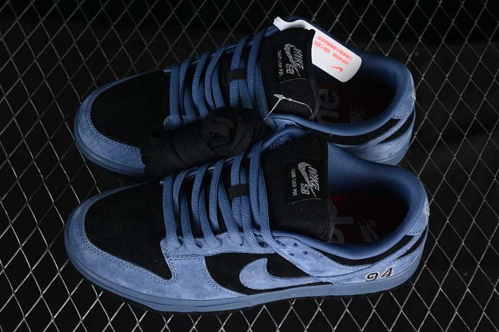 Overhead view of the blue and black sneaker pair with extra black laces