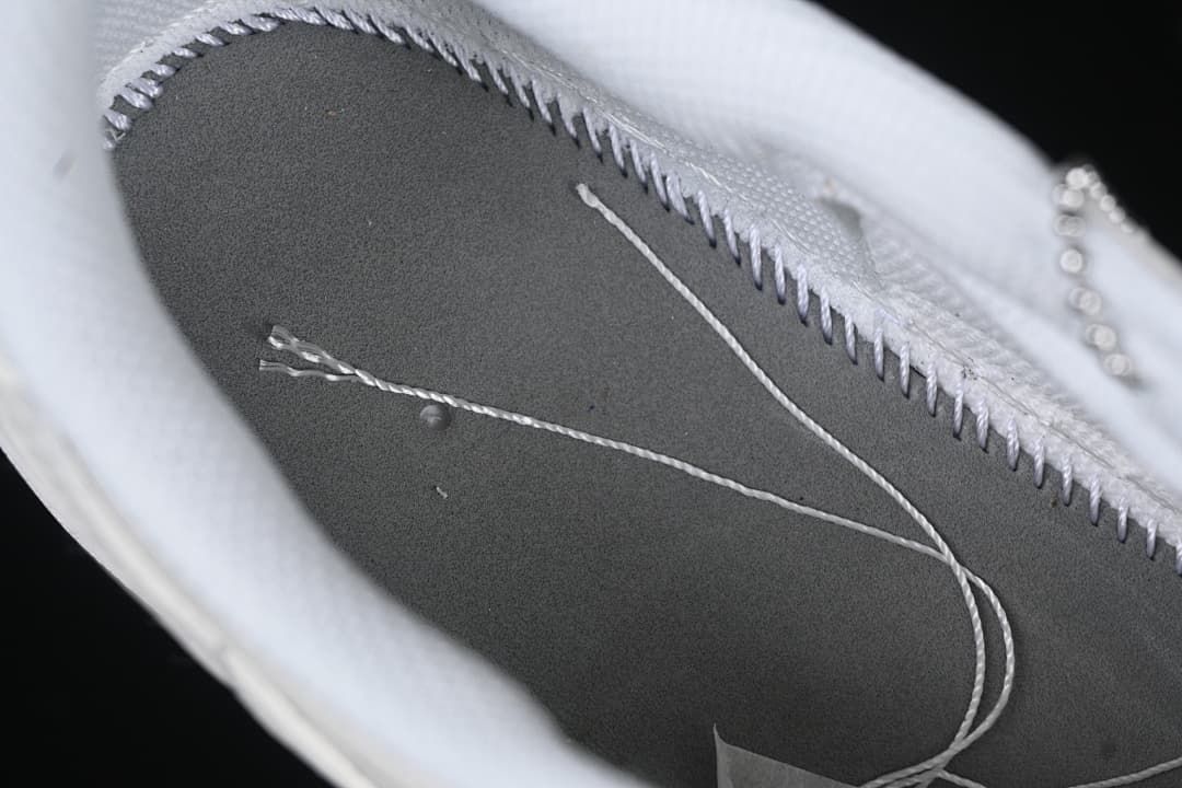 Close-up of the sneaker interior stitching and removable insole area.