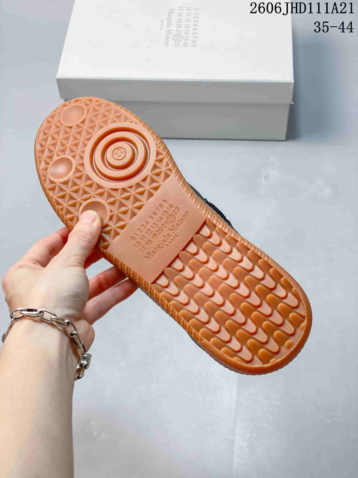 Underside of the sneaker showing its textured gum-colored sole