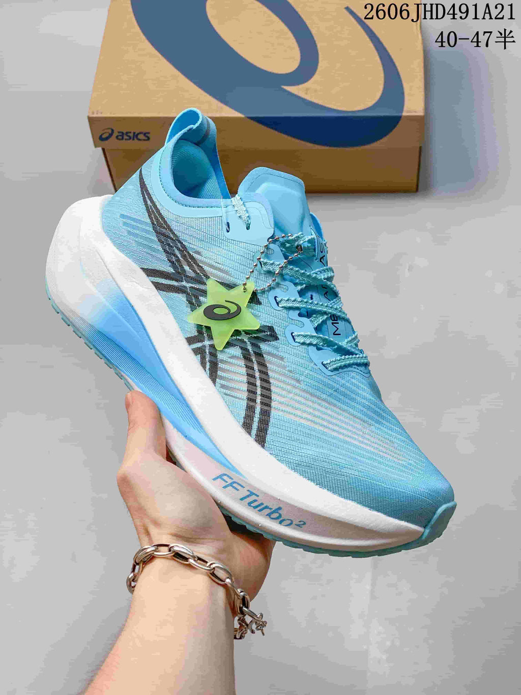 Close-up side view of a light blue ASICS MEGABLAST shoe with FF TURBO² midsole marking