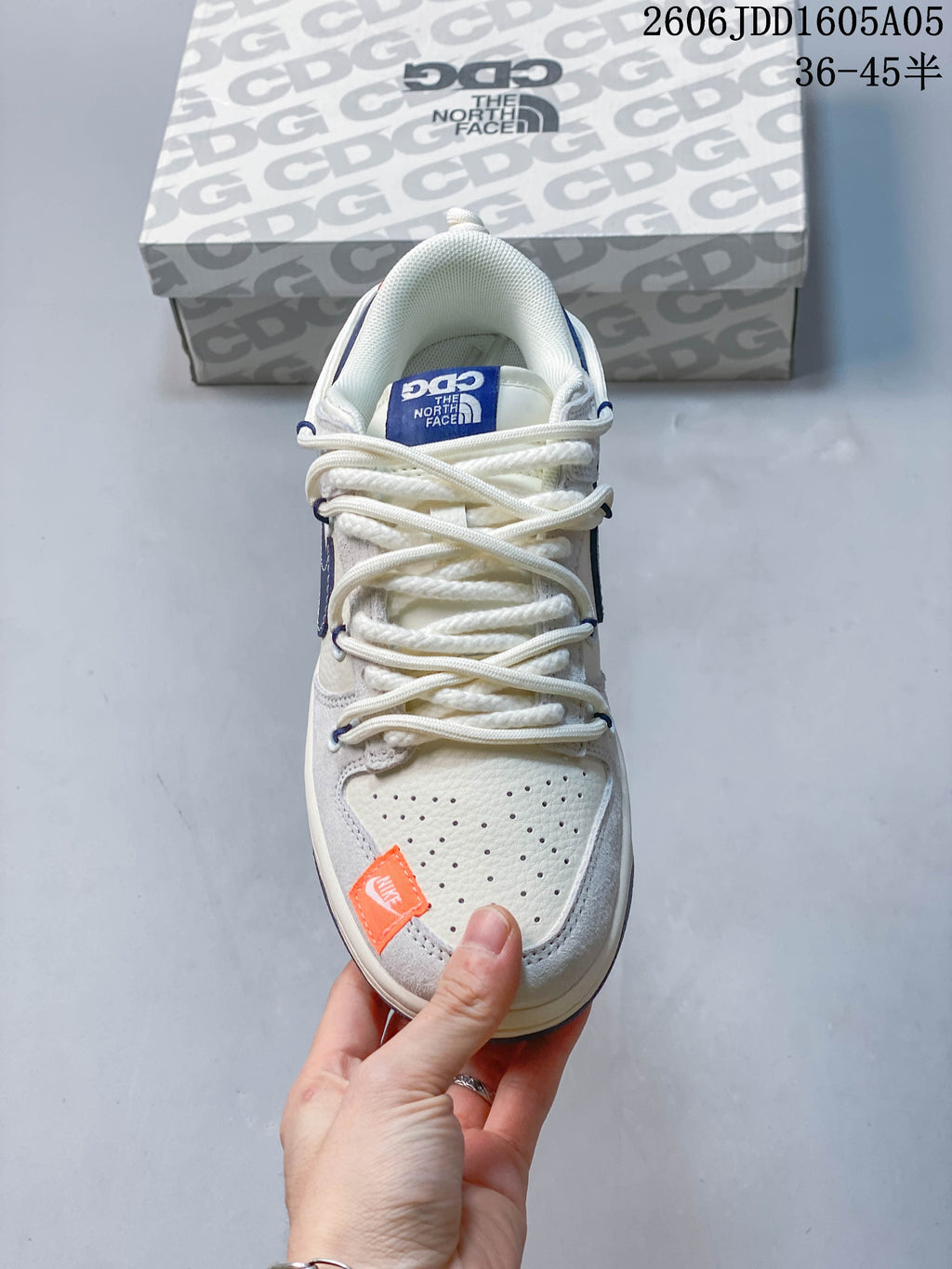 Top view showing the perforated toe, rope-style laces, and orange detail on a Nike SB Dunk Low.