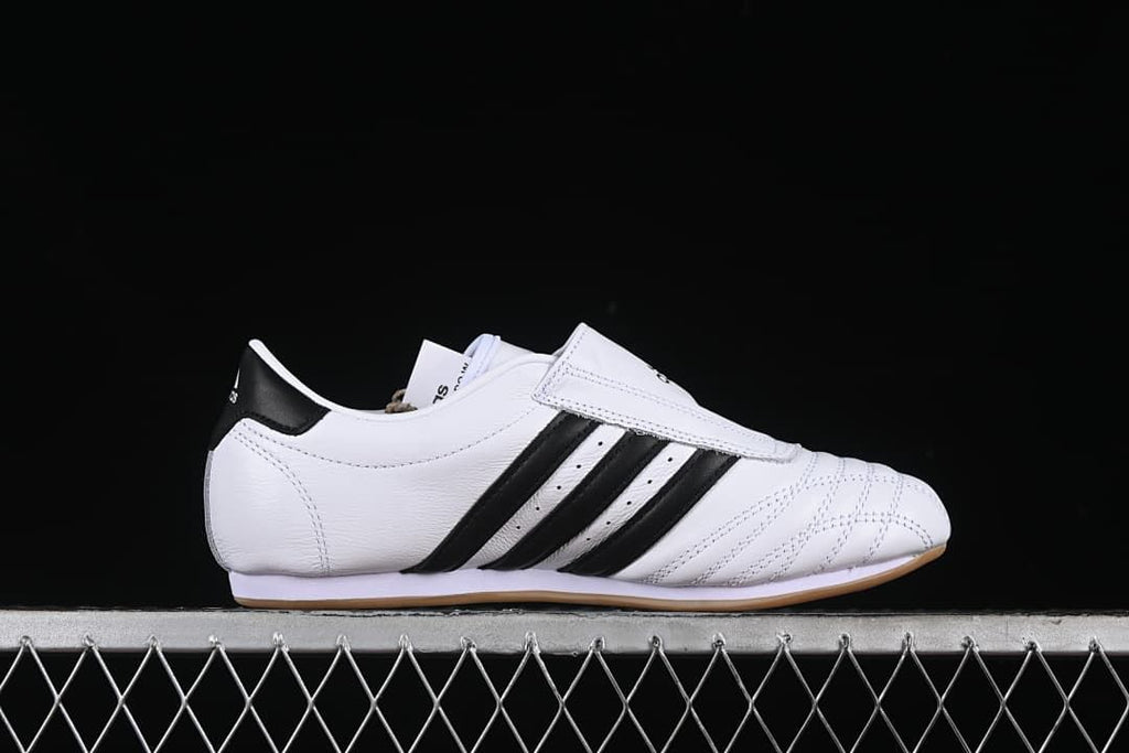 Side profile showing the low-cut shape, instep strap, and black stripes.