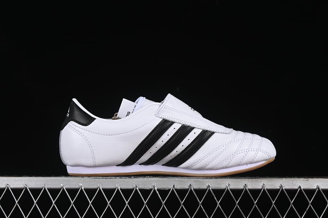 Side profile showing the low-cut shape, instep strap, and black stripes.