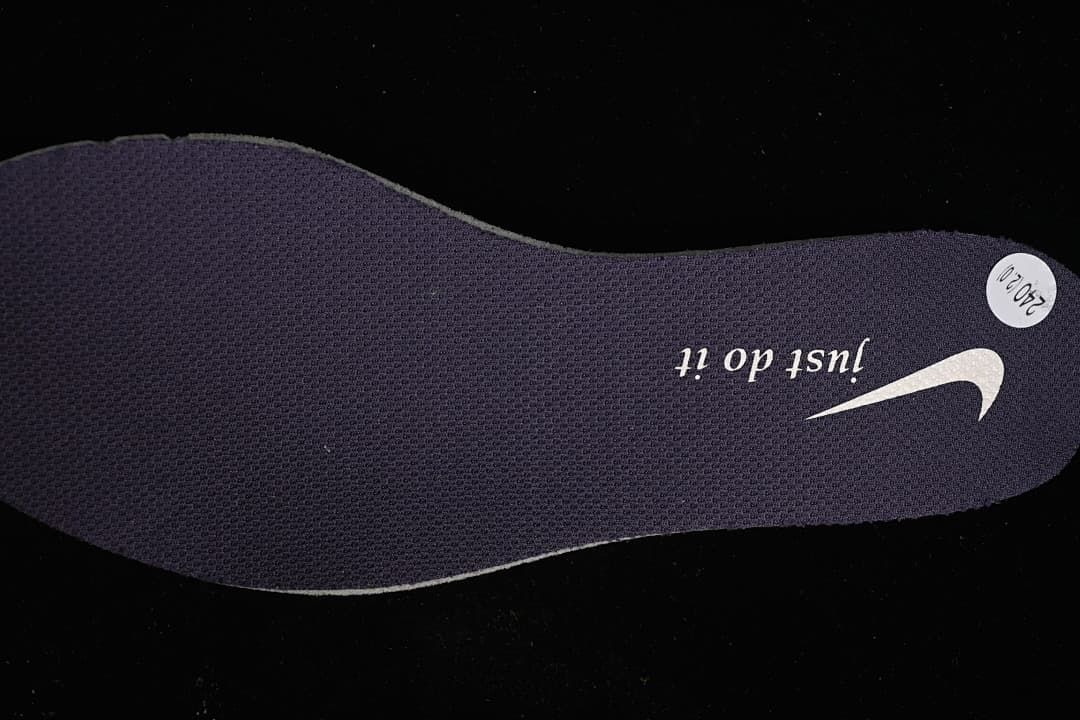 Dark shoe insole with printed branding and a round size sticker.