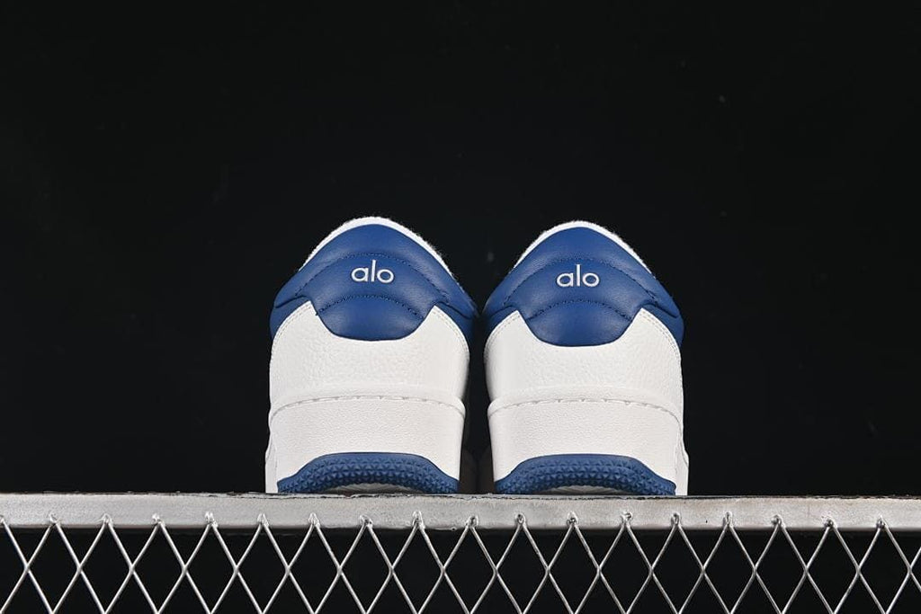 Rear view of both sneakers showing navy heel panels and white midsoles