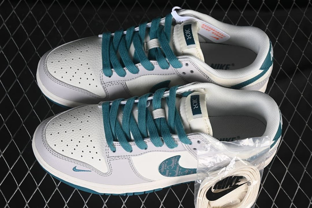 Top view of the pair showing teal laces, perforated toe boxes, and spare white laces