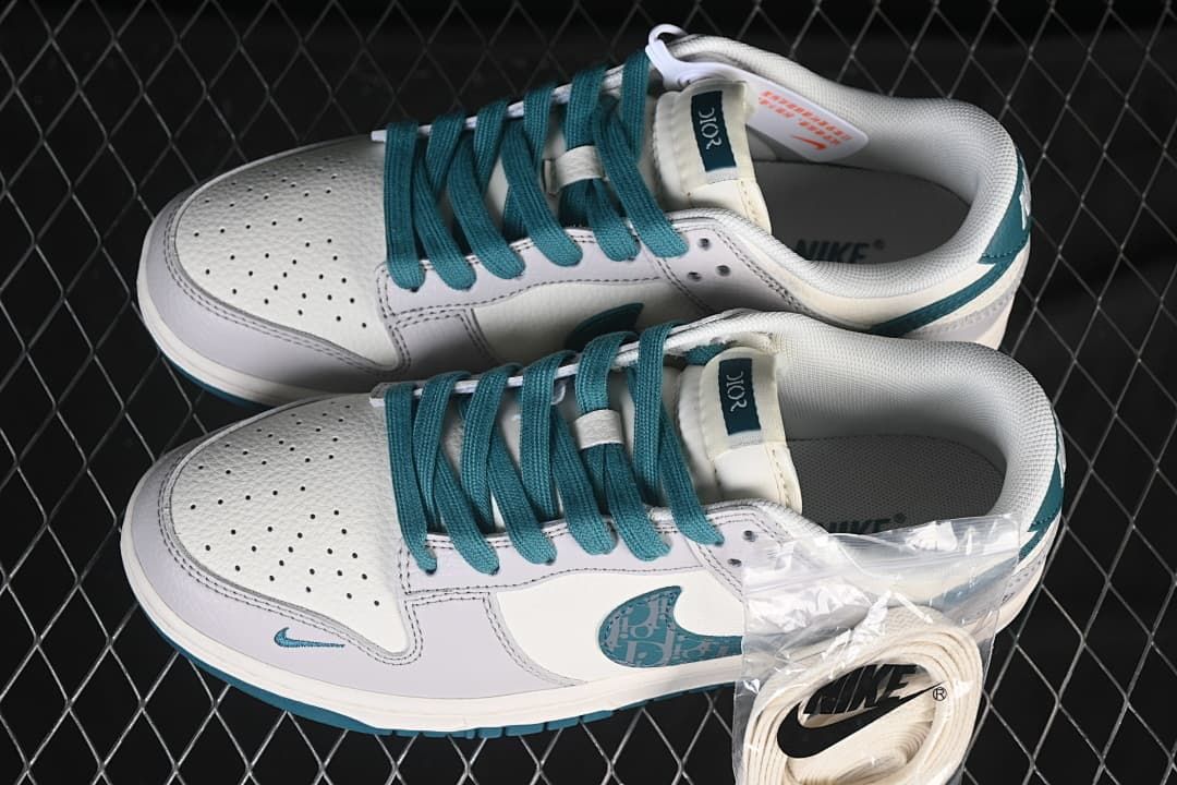 Top view of the pair showing teal laces, perforated toe boxes, and spare white laces