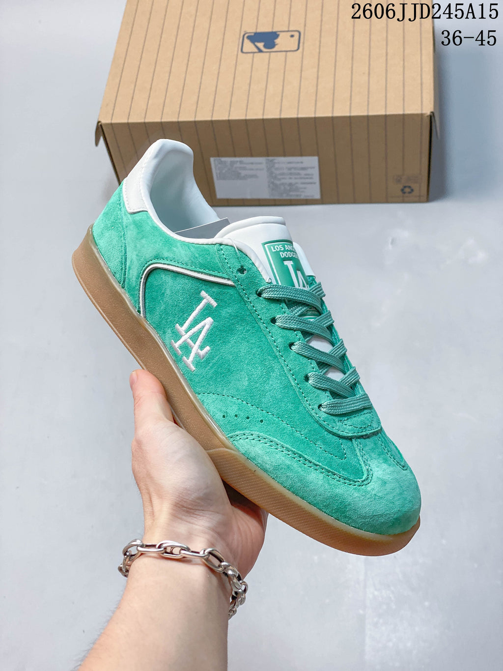 Side view of the teal sneaker featuring an LA graphic and gum-colored sole.