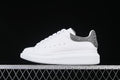 Side view of a white low-top sneaker with a crystal-embellished silver-tone heel tab.